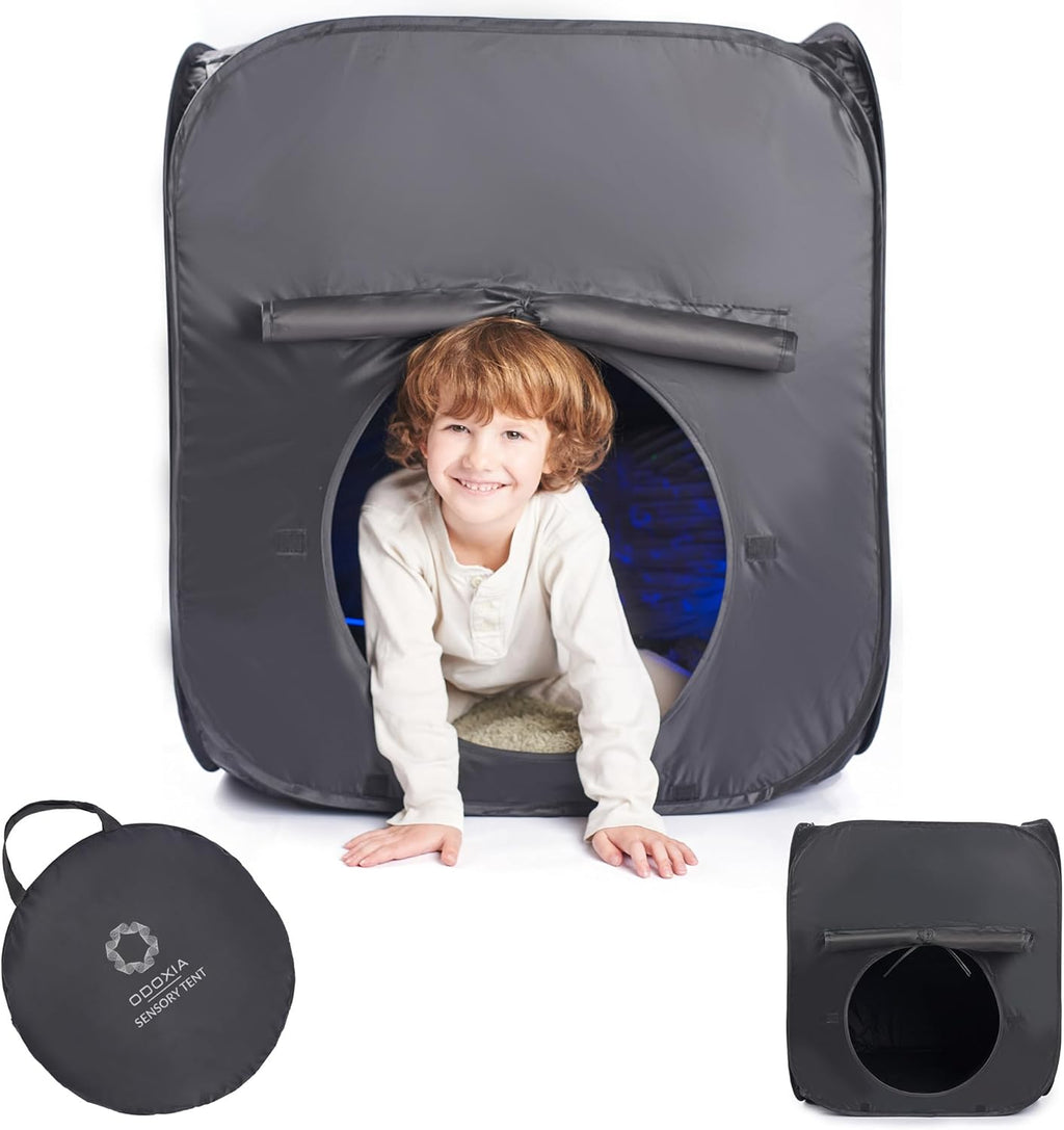 Child playing inside a gray sensory tent with a carrying case on a white background