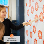 Child interacting with an educational wall display featuring letters and numbers.