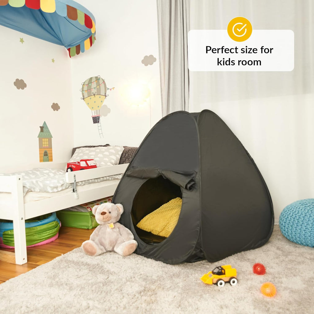 Black sensory play tent in a child's room with toys and colorful decorations.