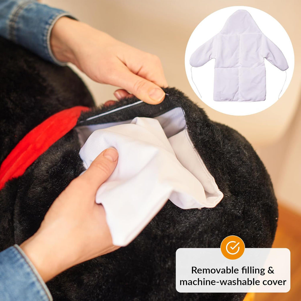 Person cleaning a weighted plush toy, showing a removable filling and machine-washable cover feature.