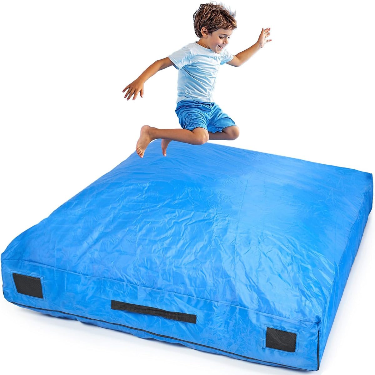 Child jumping on a large blue crashpad