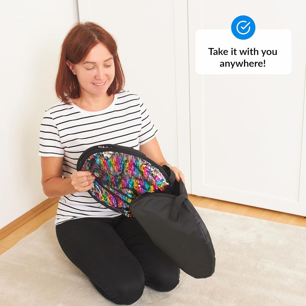 Woman holding a colorful sequin mat with text 'Take it with you anywhere!' on a white background