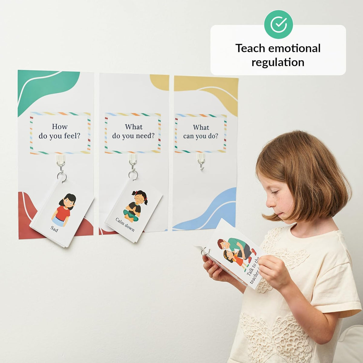 Child holding a book with emotional regulation cards on a white background