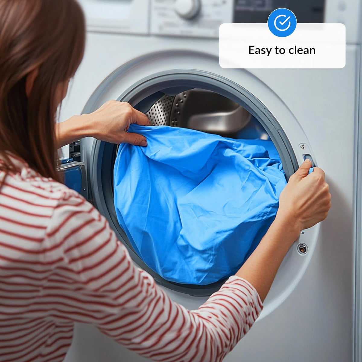 Person loading a cover into a washing machine with 'Easy to clean' label.