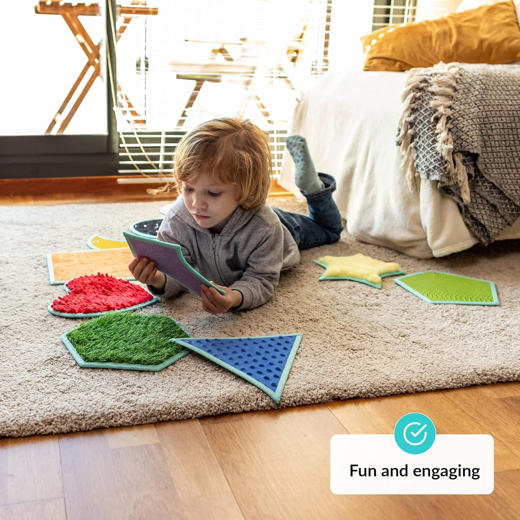 Child playing with colorful geometric mats on a carpeted floor
