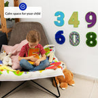 Child playing with sensory number with decorative numbers on the wall.