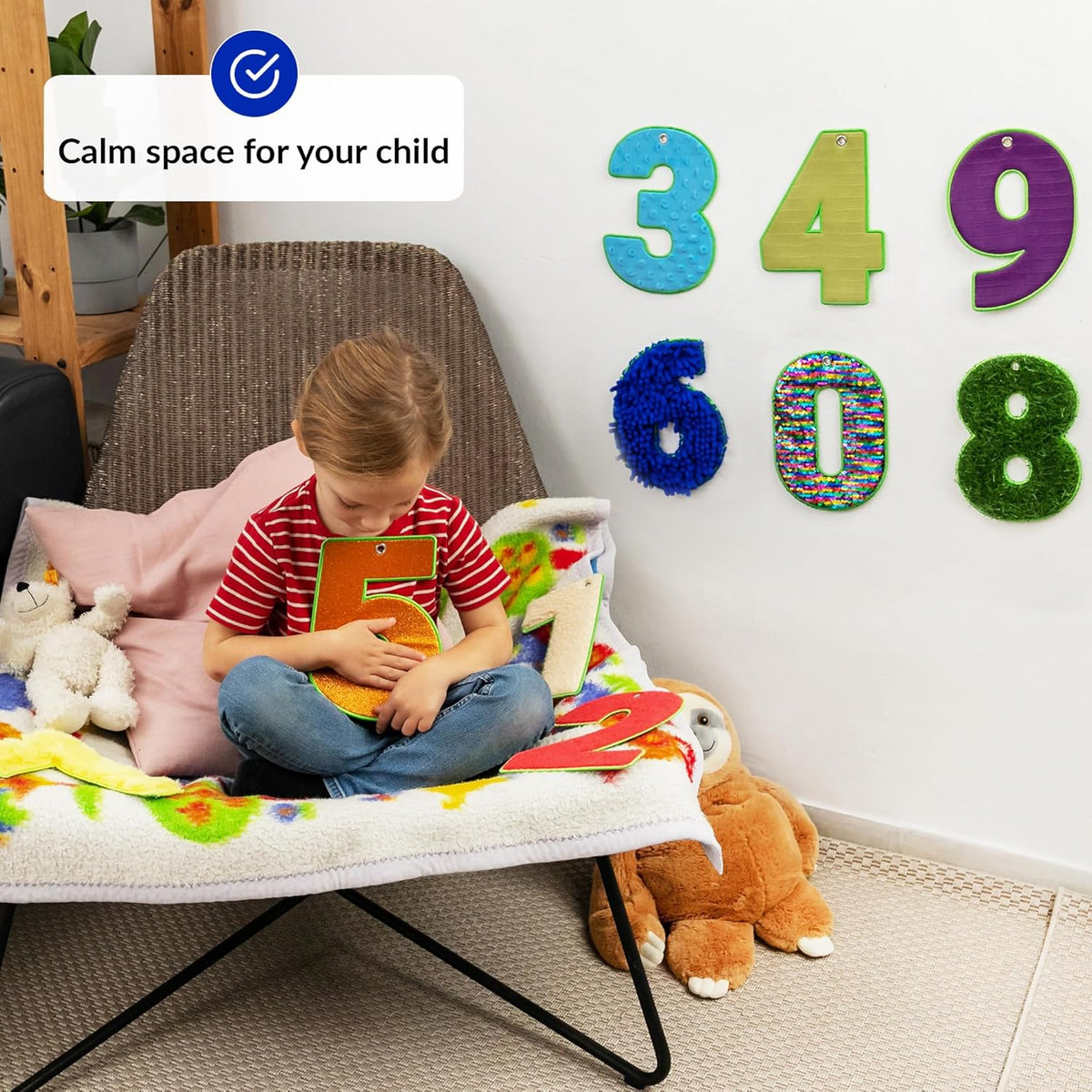 Child playing with sensory number with decorative numbers on the wall.