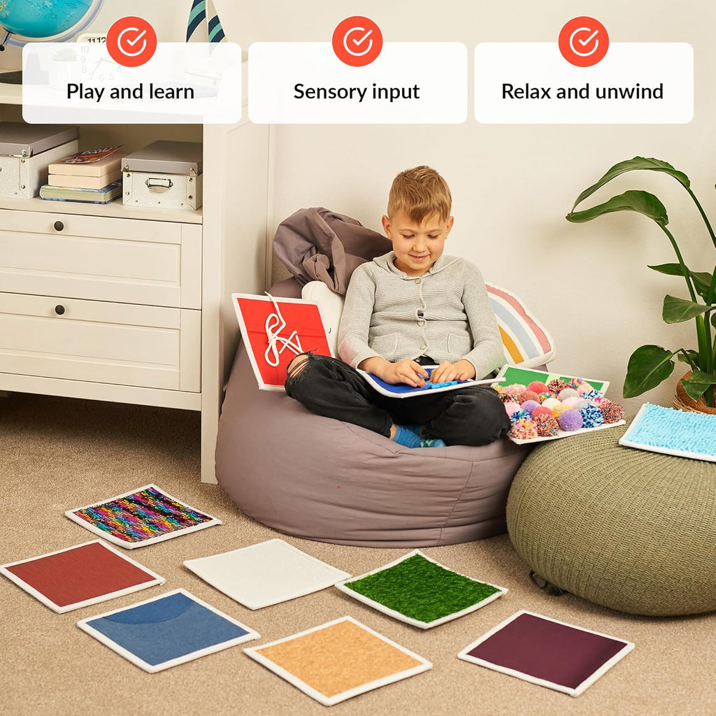 Child sitting on a bean bag playing and learning with sensory tiles