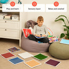 Child sitting on a bean bag playing and learning with sensory tiles