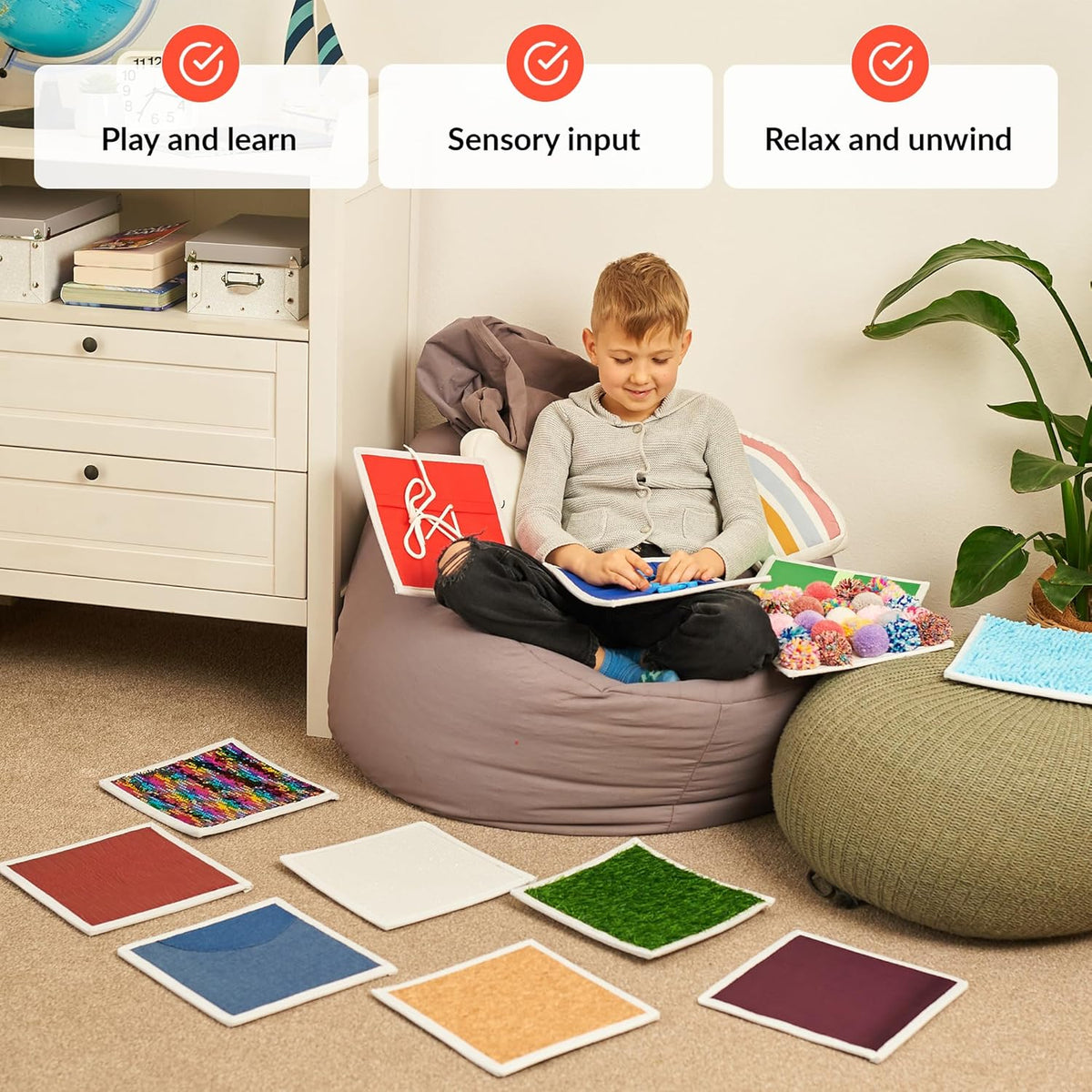 Child sitting on a bean bag playing and learning with sensory tiles