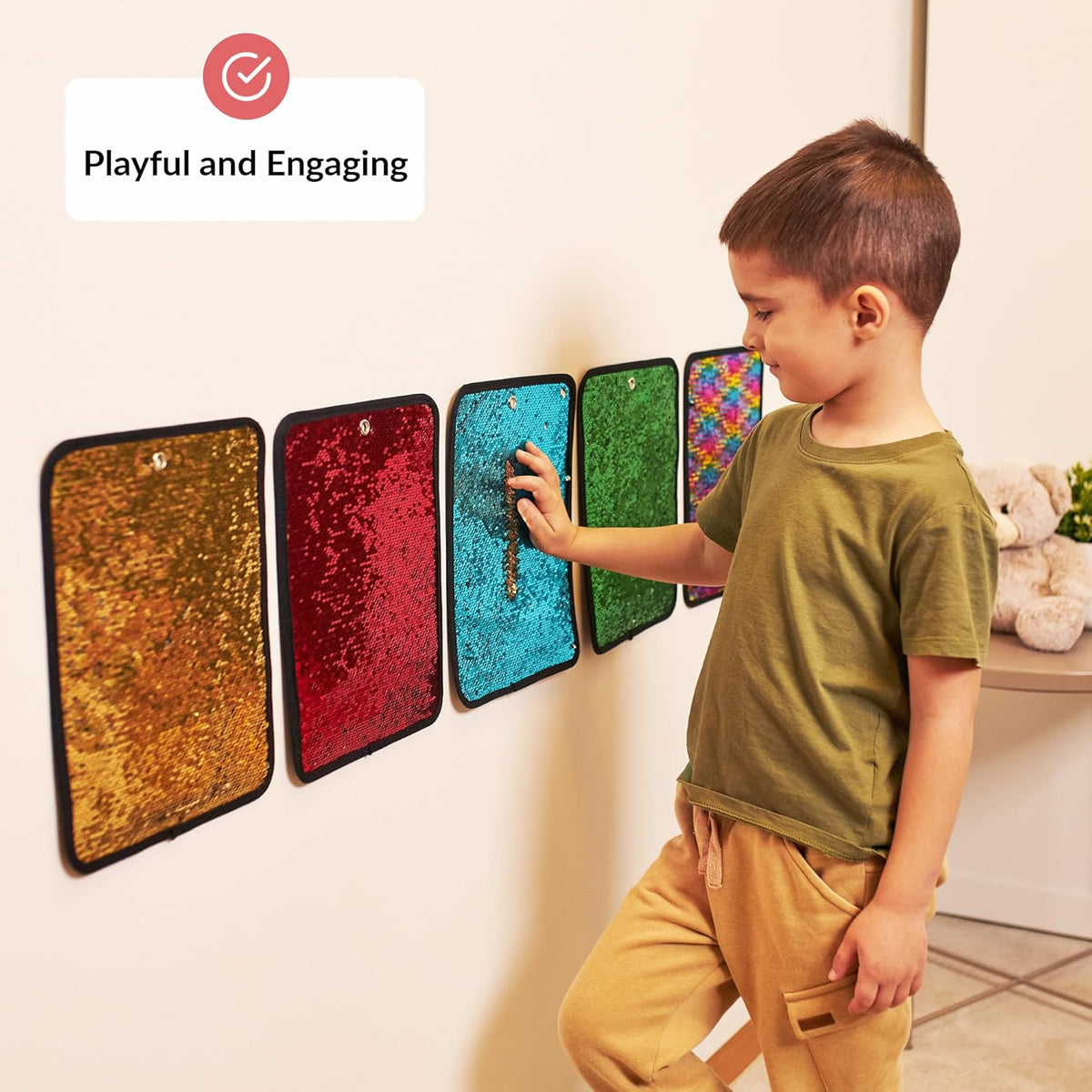 Child interacting with colorful textured sequin panels on a wall, with text 'Playful and Engaging'.