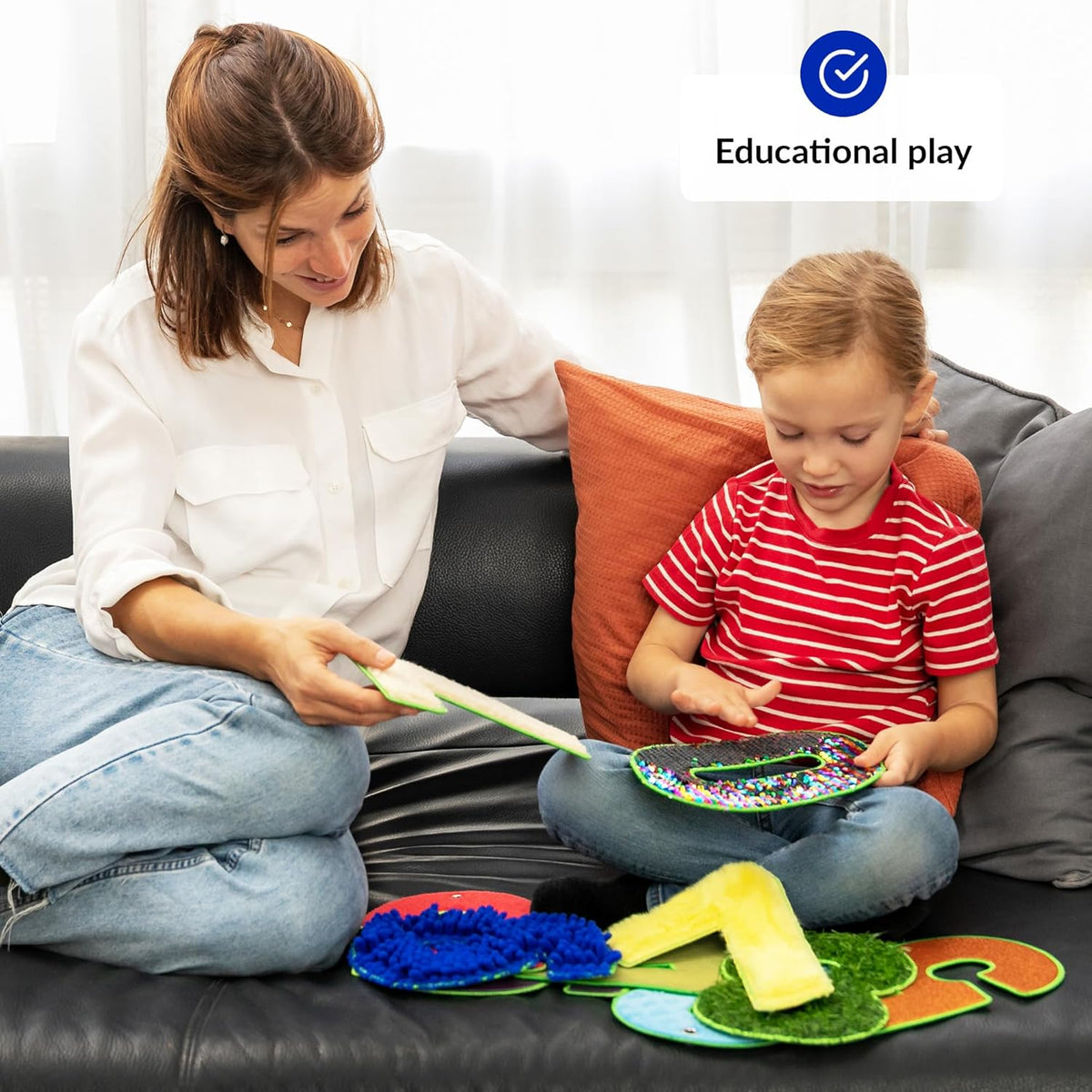 Woman and child playing with educational toys on a couch