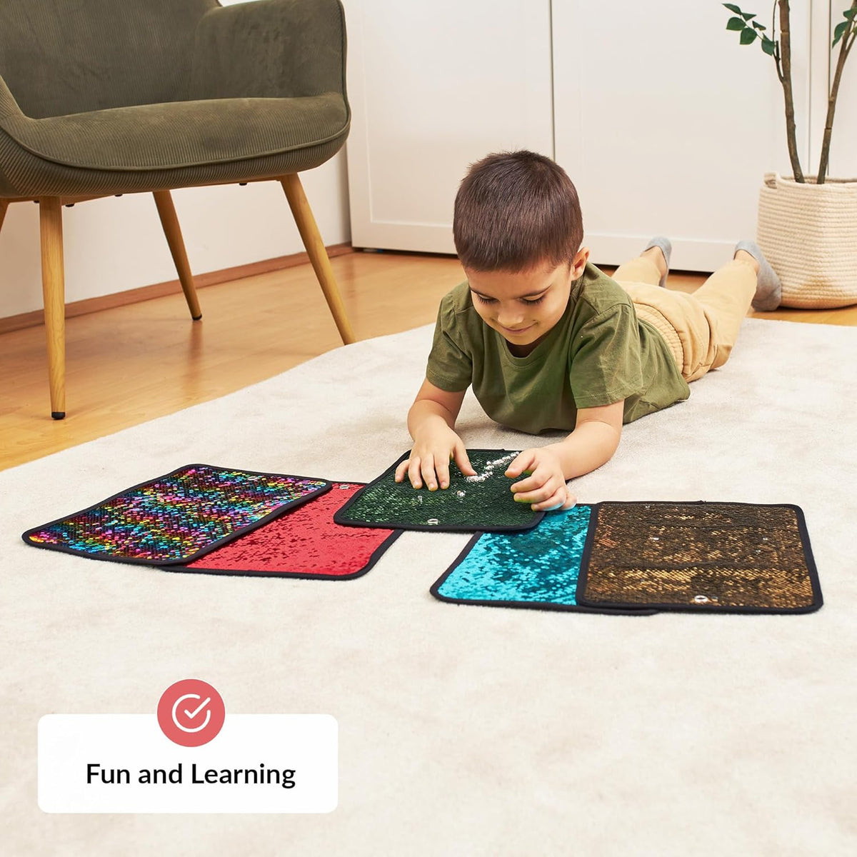 Child playing with colorful mats on a carpeted floor, with a chair and plant in the background.