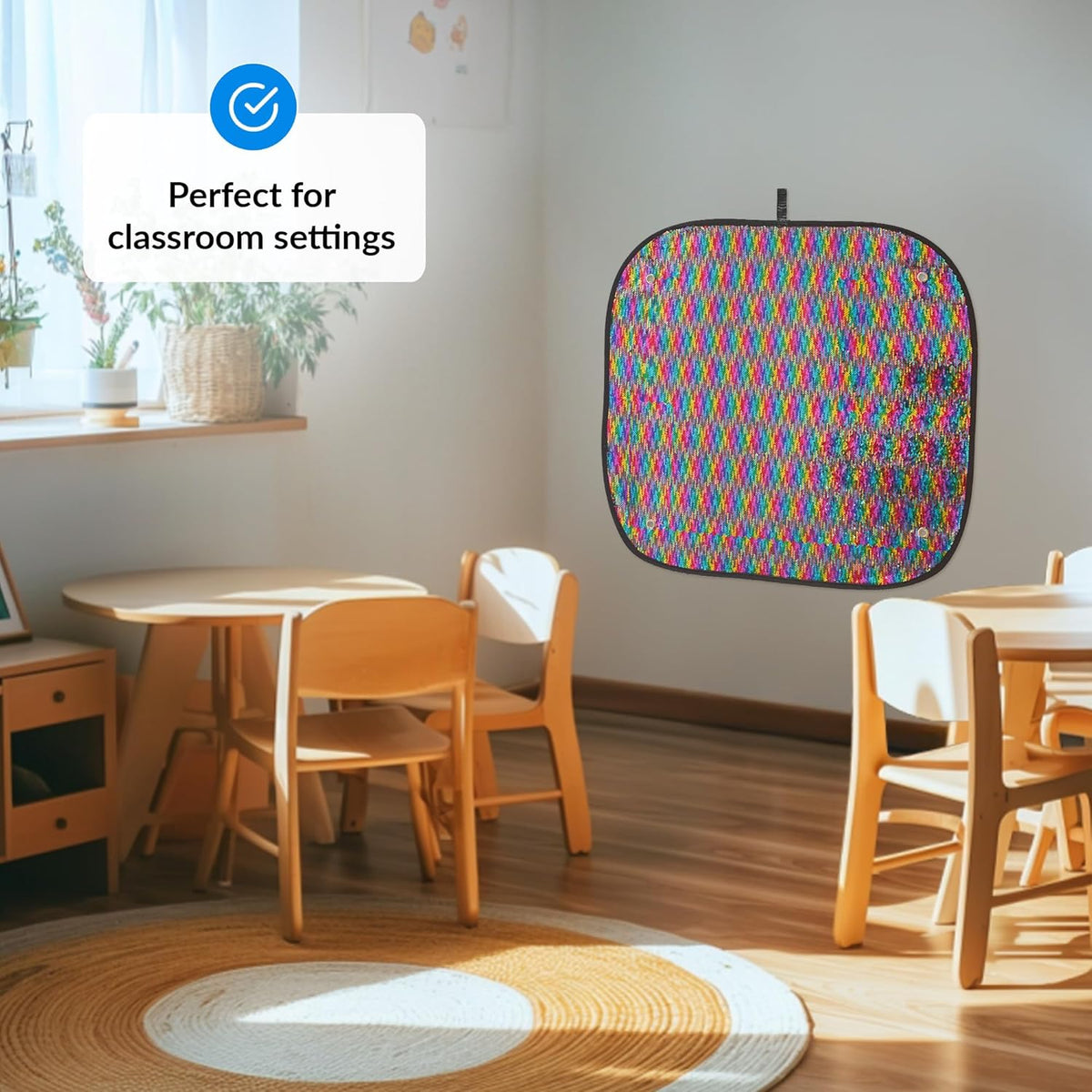 Colorful geometric patterned sequins wall mat hanging in a classroom with wooden tables and chairs.