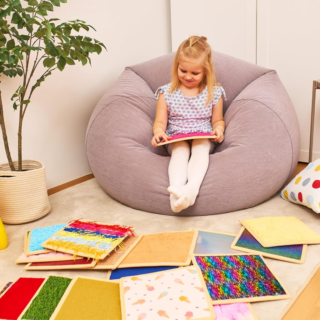 Child playing with colourful sensory tiles