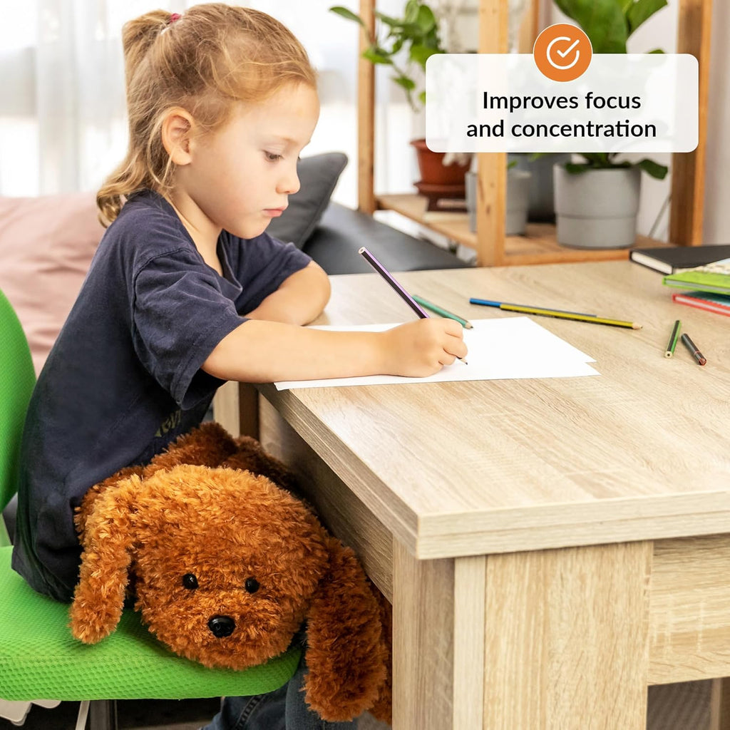 Child sitting at a desk with a lapdog, writing on paper, with text 'Improves focus and concentration'