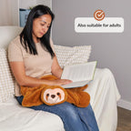 Woman reading a book with a sloth lap animal on her lap, sitting on a couch.