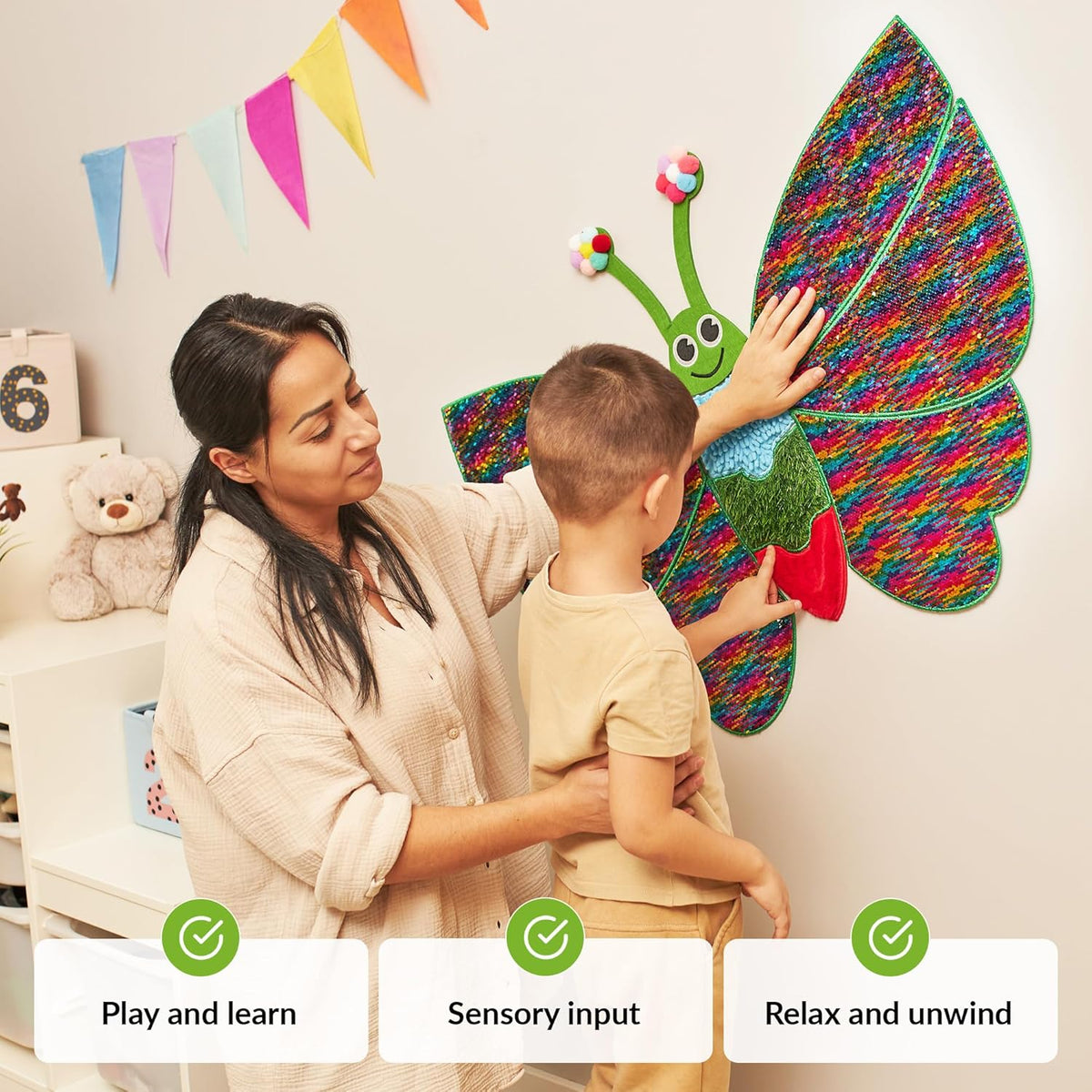 Woman and autistic child playing with a colorful butterfly wall toy.