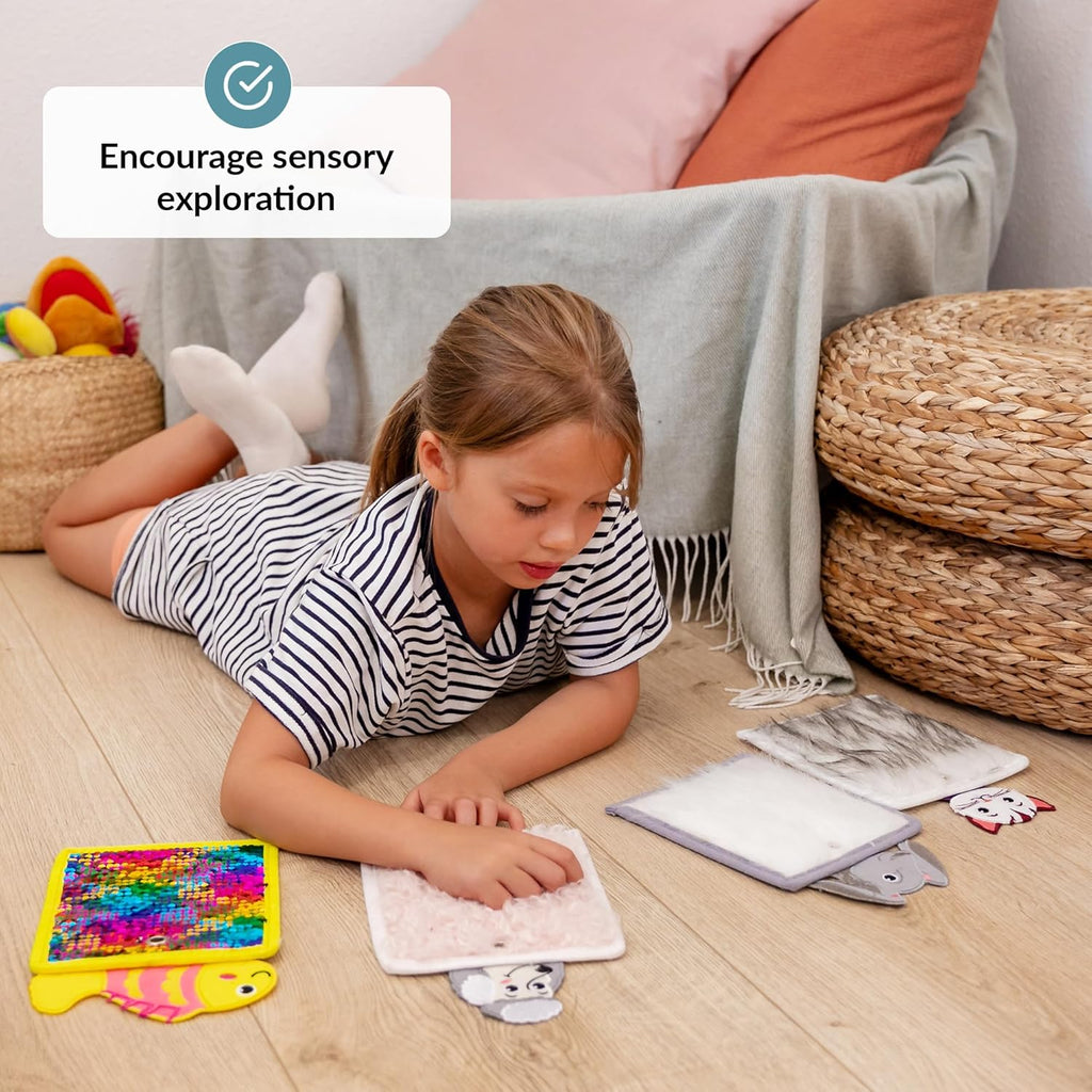 Child playing with sensory toys on the floor, encouraging sensory exploration.