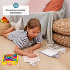 Child playing with sensory toys on the floor, encouraging sensory exploration.
