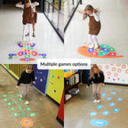 Children playing on colorful floor games in a classroom setting.