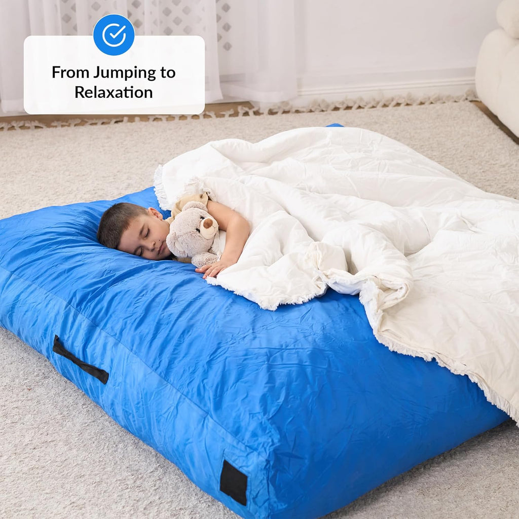 Child lying on a sensory pad with a blanket and a sensory toy