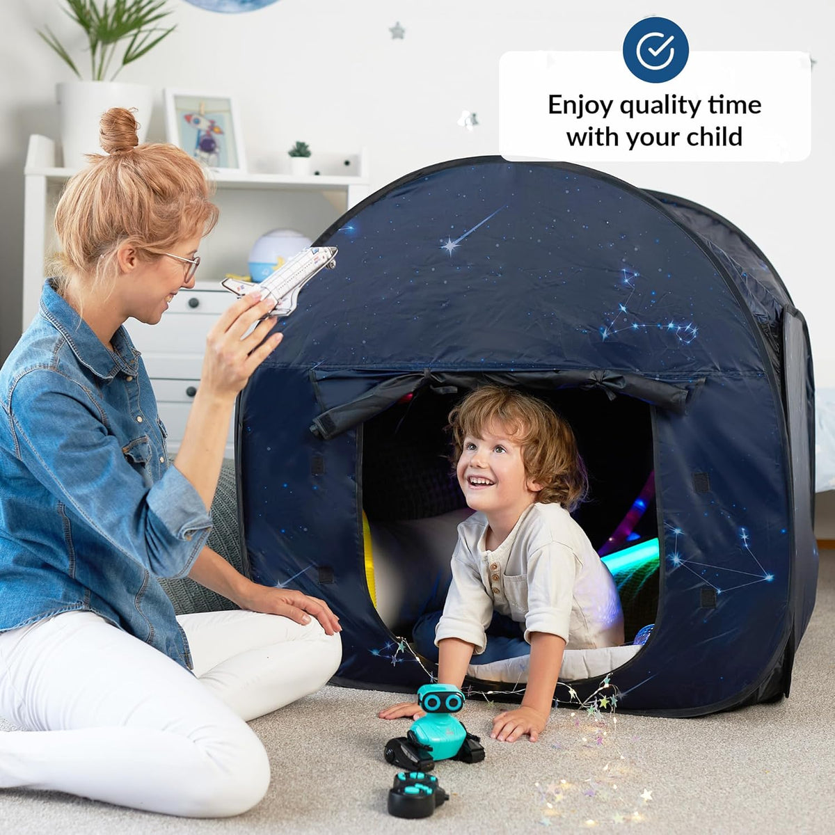 Woman and autistic child playing with a toy robot in a dark tent, with text 'Enjoy quality time with your child'.