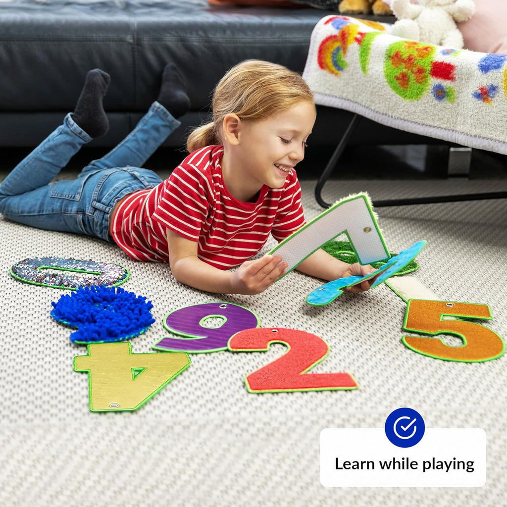 Child playing with educational number sensory tiles on a carpeted floor
