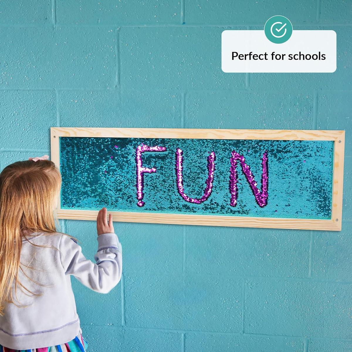 Child interacting with a sequins board displaying the word 'FUN' against a teal wall, with a label indicating it's 'Perfect for schools'.