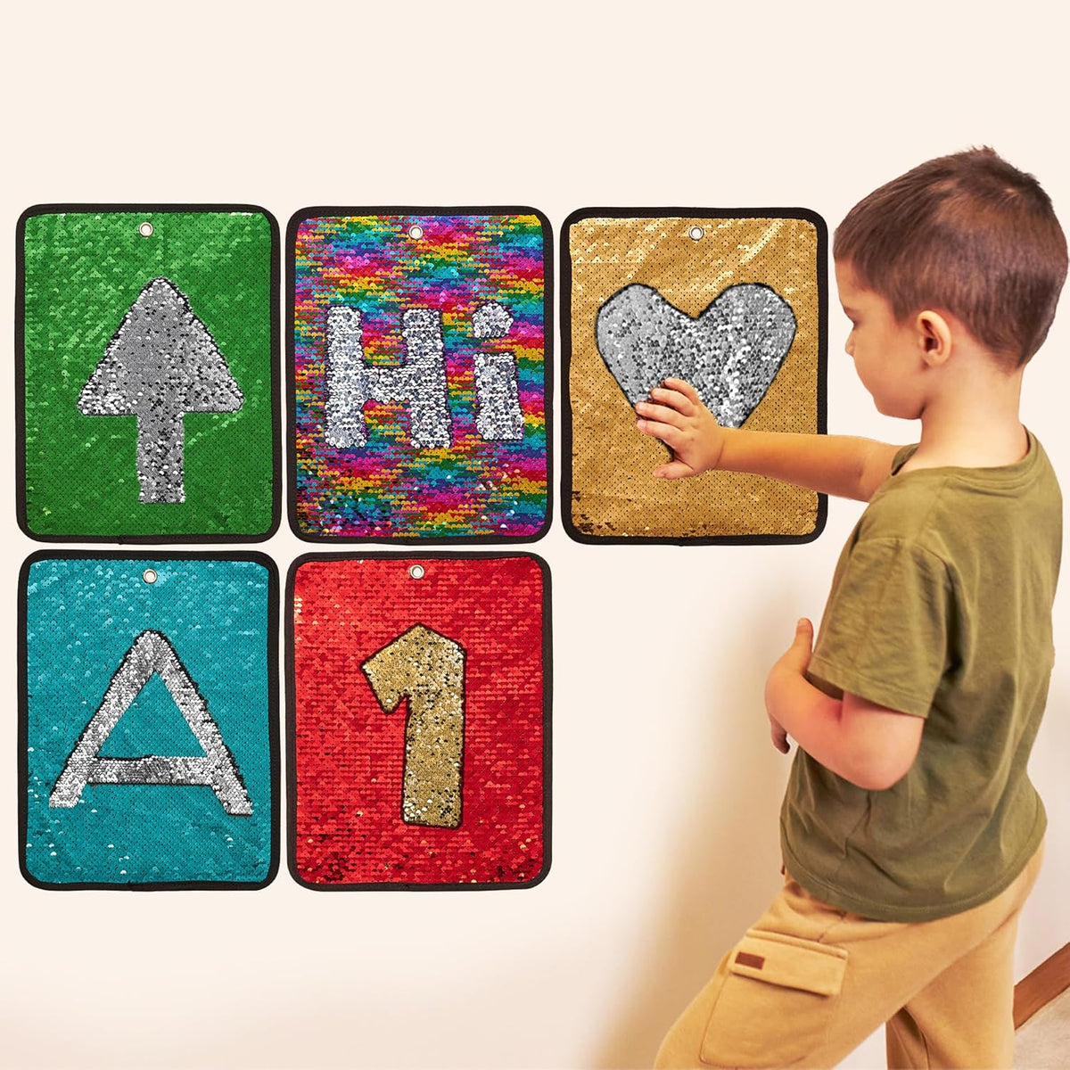 Child interacting with colorful letter and number sequin wall stickers on a white background