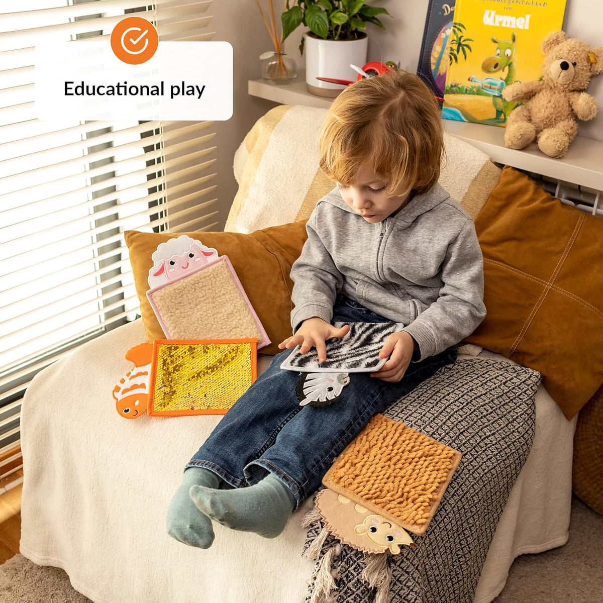 Child sitting on a couch with educational toys and books, labeled 'Educational play'.