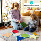 Woman and child playing with colorful sensory mats on a carpeted floor.