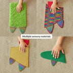 Four different textured wall mats for sensory play, each with a child's hand touching them.